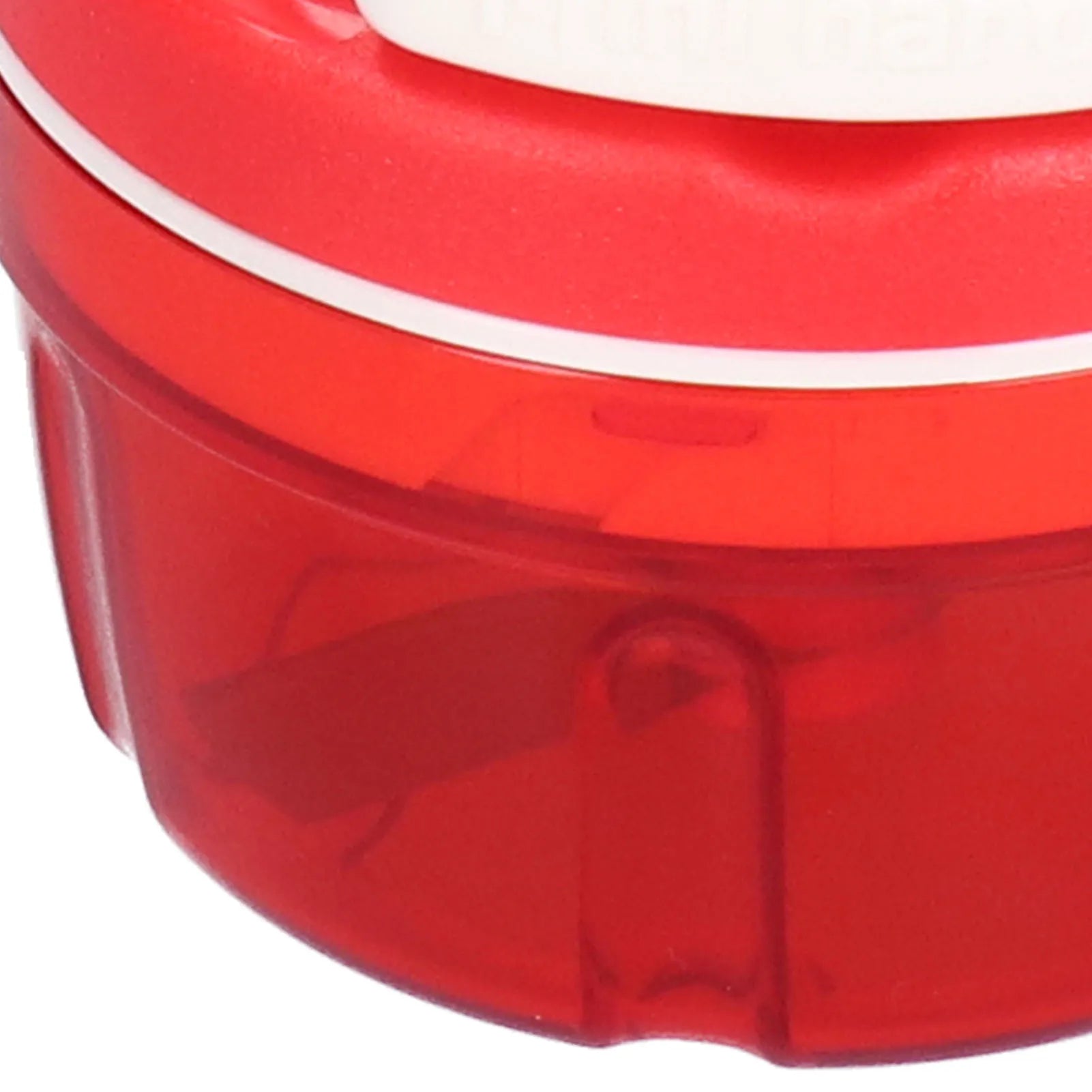 Close-up of red plastic container with a transparent lower section and a solid red upper lid