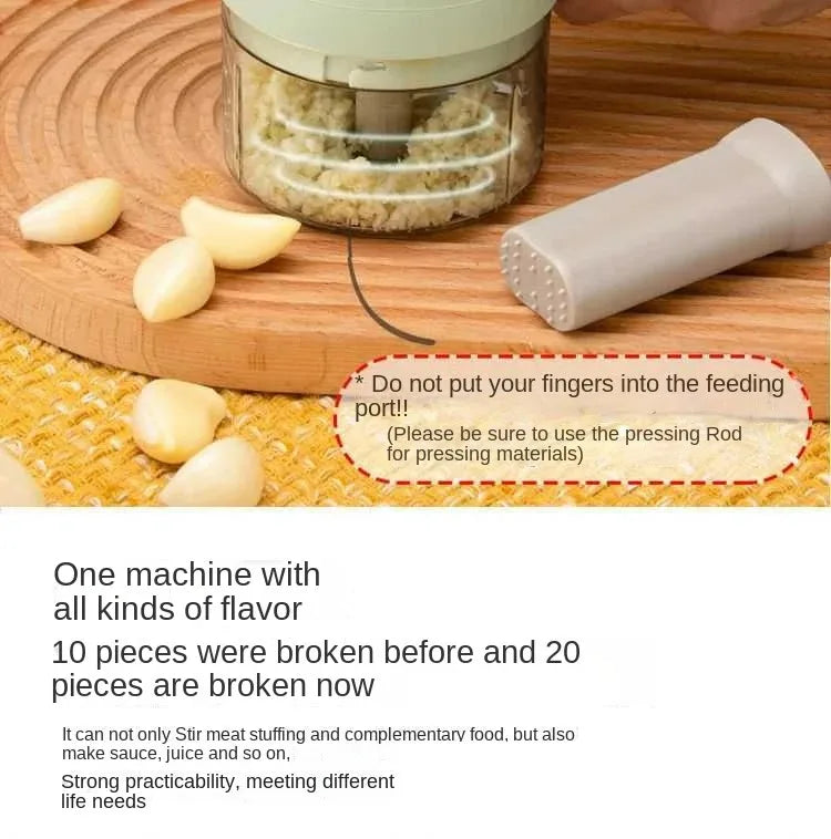 Electric garlic chopper with pressing rod and peeled garlic cloves on wooden cutting board