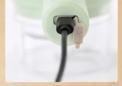 Close-up of black and white USB cables plugged into a white device port