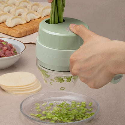 Hand using green manual vegetable slicer to cut green onions with dumplings, minced meat, and wrappers nearby