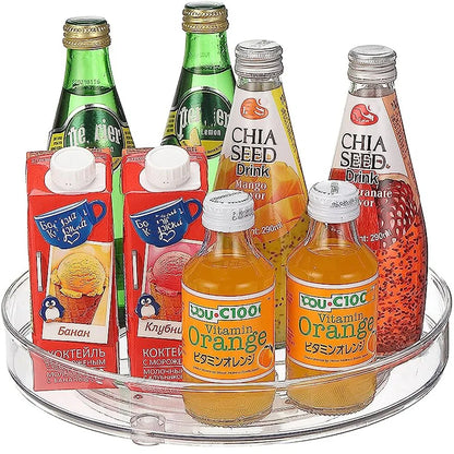 Assorted fruit drinks including Perrier lemon, chia seed drinks, orange vitamin drink, and Russian fruit milk cocktails on a clear tray